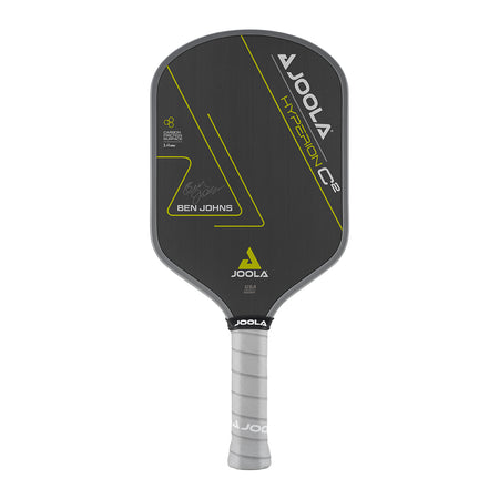 White Background Image: Ben Johns Hyperion C2 Pickleball paddle. Black surface with yellow lines and Ben Johns' signature. Grey handle and grey edge guard with white JOOLA logo.